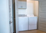Thumbnail 15 of 36 - A white dishwasher and washing machine in a kitchen.