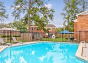 Thumbnail 5 of 29 - our apartments have a swimming pool with a black fence at Savan Pointe Townhomes East and West, Savannah, 31406