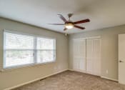 Thumbnail 11 of 29 - an empty living room with a ceiling fan and a window at Savan Pointe Townhomes East and West, Georgia
