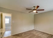 Thumbnail 12 of 29 - an empty living room with a ceiling fan at Savan Pointe Townhomes East and West, Georgia, 31406