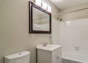 Thumbnail 14 of 29 - a bathroom with a sink and a mirror and a toilet at Savan Pointe Townhomes East and West, Savannah, 31406