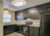 Thumbnail 17 of 29 - a kitchen with stainless steel appliances and granite counter tops at Savan Pointe Townhomes East and West, Savannah, GA 31406