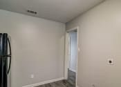Thumbnail 18 of 29 - the living room of an empty apartment with a door to the hallway at Savan Pointe Townhomes East and West, Georgia, 31406