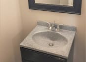 Thumbnail 26 of 29 - a bathroom with a sink and a mirror at Savan Pointe Townhomes East and West, Savannah