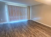 Thumbnail 28 of 29 - an empty living room with wood flooring and a window at Savan Pointe Townhomes East and West, Savannah, 31406 