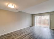 Thumbnail 29 of 29 - an empty living room with a sliding glass door and a window at Savan Pointe Townhomes East and West, Savannah, GA 31406
