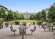 Thumbnail 3 of 22 - an empty patio at an event with tables and chairs
