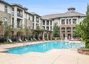 Thumbnail 5 of 22 - a swimming pool with a building in the background