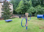 Thumbnail 1 of 22 - a playground with a blue slide and a rocking horse