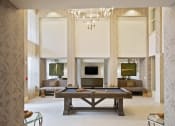Thumbnail 21 of 22 - a living room with a pool table and a fireplace