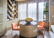 Thumbnail 17 of 22 - a dining room with a glass table and orange chairs