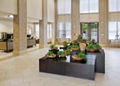 Thumbnail 15 of 22 - a lobby with a table with plants in it