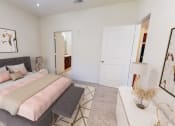 Thumbnail 22 of 22 - a bedroom with a large bed and a white closet