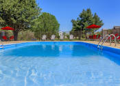 Thumbnail 25 of 53 - a swimming pool with chairs and umbrellas next to a resort style pool at The Dylan, Murfreesboro, 37129