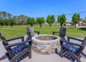 Thumbnail 35 of 53 - a fire pit with chairs and trees in a park at The Dylan, Murfreesboro, TN 37129