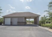 Thumbnail 22 of 49 - a garage with a roof and a driveway at Century HomePlace, Prattville, 36066