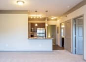 Thumbnail 24 of 49 - an empty living room with a kitchen and a at Century HomePlace, Prattville