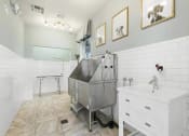 Thumbnail 26 of 49 - a white bathroom with a stainless steel tub in the middle at Century HomePlace, Alabama, 36066