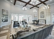 Thumbnail 2 of 38 - A large, modern living room with a dark leather couch and a fireplace.at Century Ariva, Lakeland, Florida  