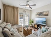 Thumbnail 4 of 48 - A living room with a grey couch and a flat screen TV.at Century Hampton Roads, Suffolk Virginia  