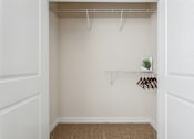Thumbnail 18 of 48 - A small closet with a shelf and a plant.at Century Hampton Roads, Suffolk, VA  