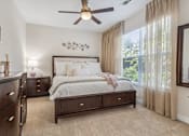 Thumbnail 21 of 48 - A bedroom with a large bed, a dresser, and a ceiling fan.at Century Hampton Roads, Suffolk, VA 23435  