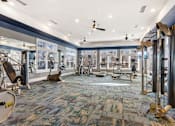 Thumbnail 27 of 48 - A gym with a variety of equipment including treadmills, weights, and exercise machines.at Century Hampton Roads, Suffolk Virginia  