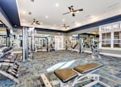 Thumbnail 29 of 48 - A gym with a variety of equipment including treadmills, weights, and exercise machines.at Century Hampton Roads, Virginia  
