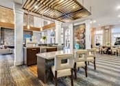 Thumbnail 31 of 48 - A modern kitchen with a wooden ceiling and a dining area with chairs.at Century Hampton Roads, Virginia  