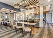 Thumbnail 32 of 48 - A modern kitchen with a dining table and chairs.at Century Hampton Roads, Suffolk, VA  