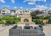 Thumbnail 43 of 48 - A patio with a fireplace and seating area.at Century Hampton Roads, Suffolk, 23435  