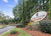 Thumbnail 2 of 24 - A sign for Ridge Crossings residential community is displayed in front of a landscaped area at Ridge Crossings Apartments, Hoover, AL