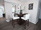Thumbnail 22 of 24 - A dining room with a wooden table and chairs at Ridge Crossings Apartments, Hoover