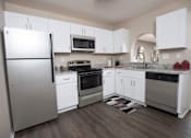 Thumbnail 20 of 24 - A kitchen with white cabinets and a refrigerator at Ridge Crossings Apartments, Hoover, 35244
