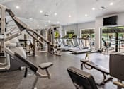 Thumbnail 12 of 24 - A gym with a variety of equipment including treadmills, weights, and exercise machines at Ridge Crossings Apartments, Hoover, 35244