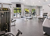 Thumbnail 13 of 24 - A gym with a variety of equipment including treadmills, weights, and exercise machines at Ridge Crossings Apartments, Hoover, AL