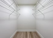 Thumbnail 12 of 18 - Empty white refrigerator with wood flooring.