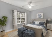 Thumbnail 3 of 18 - A bedroom with a large bed, a ceiling fan, and a potted plant.