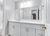 Thumbnail 17 of 35 - Bathroom with large mirror and storage at Parkside at Sandy Springs Atlanta, GA