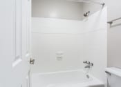 Thumbnail 18 of 35 - Spacious tub and shower with tiled walls at Parkside at Sandy Springs Atlanta, GA