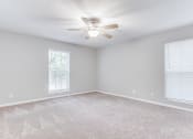 Thumbnail 16 of 35 - Spacious bedroom with ceiling fan and carpet at Parkside at Sandy Springs Atlanta, GA