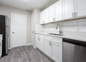Thumbnail 26 of 35 - Gourmet kitchen with wood like flooring at Parkside at Sandy Springs Atlanta, GA