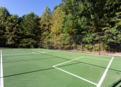 Thumbnail 30 of 49 - a tennis court with trees in the background on a sunny day  at Peaks at Gainesville, Gainesville, GA