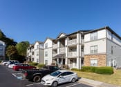 Thumbnail 6 of 49 - an apartment building with cars parked in a parking lot  at Peaks at Gainesville, Gainesville, GA, 30507