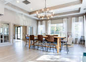 Thumbnail 12 of 49 - a dining room with a wooden table and chairs and a chandelier  at Peaks at Gainesville, Gainesville, GA