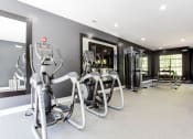 Thumbnail 18 of 49 - a gym with weights and cardio equipment in a building  at Peaks at Gainesville, Gainesville, GA