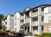 Thumbnail 4 of 49 - a row of apartments with balconies and cars parked in front  at Peaks at Gainesville, Gainesville, Georgia