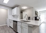 Thumbnail 32 of 49 - an open kitchen with white cabinets and a large counter top  at Peaks at Gainesville, Gainesville, Georgia