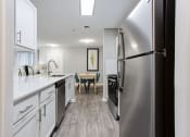 Thumbnail 38 of 49 - a renovated kitchen with white cabinets and stainless steel appliances  at Peaks at Gainesville, Gainesville, Georgia