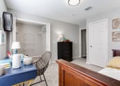 Thumbnail 46 of 49 - a bedroom with a desk and a bed and a closet  at Peaks at Gainesville, Gainesville, GA, 30507